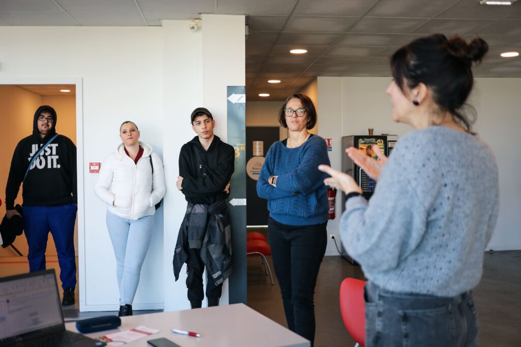 des jeunes mission locale écoutent une dame parler